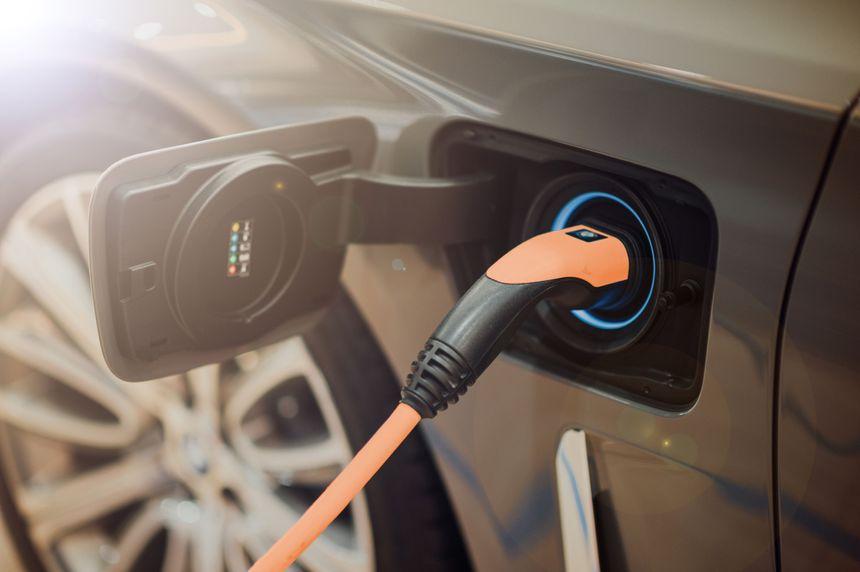 EV charger plugged into car (AI Generated)